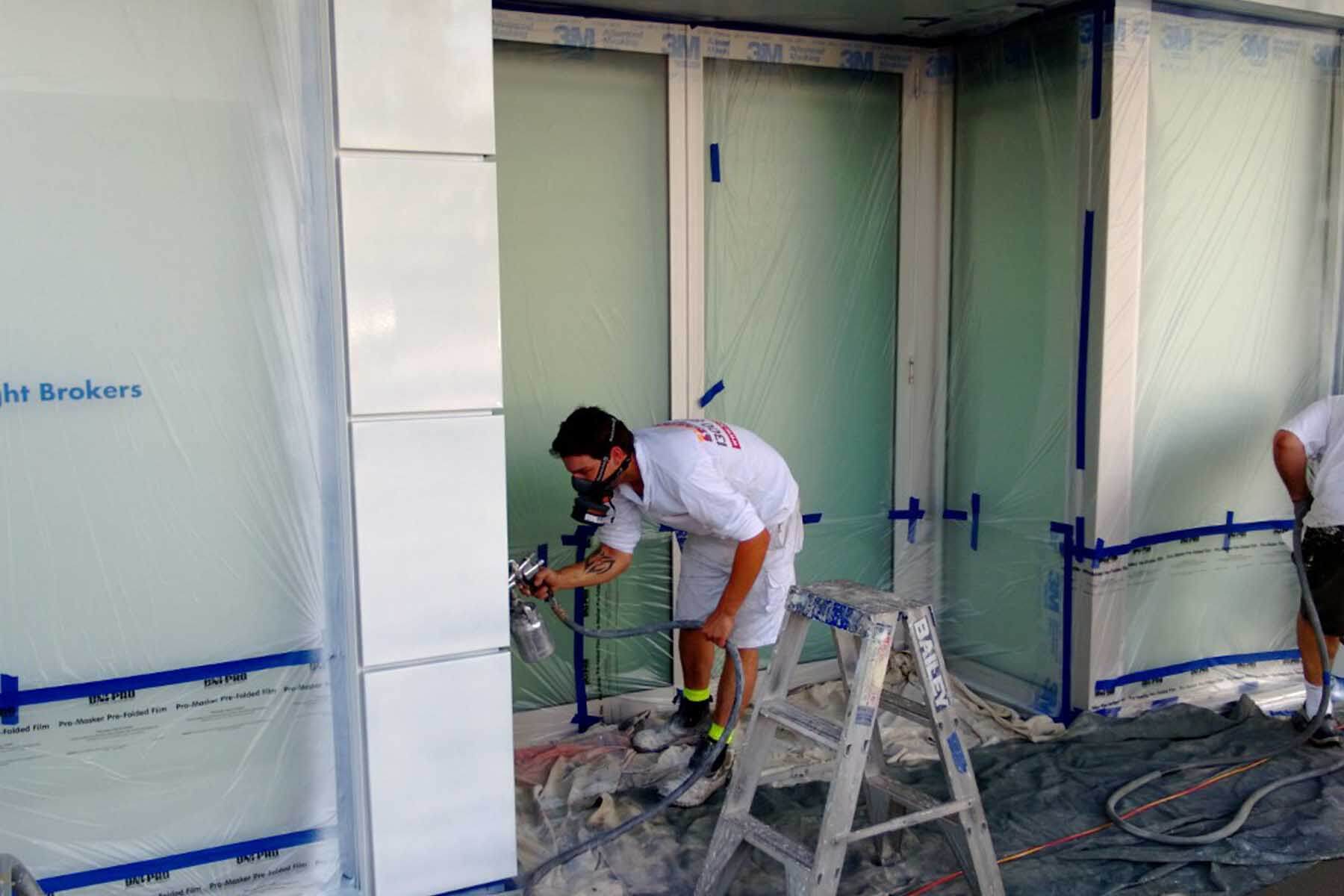 painter spraying painting commercial building Sydney CBD